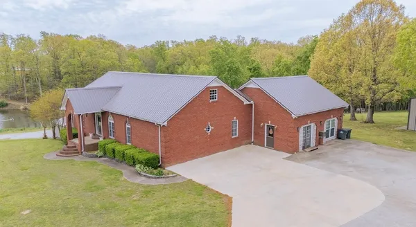 a aerial view of a house next to a yard