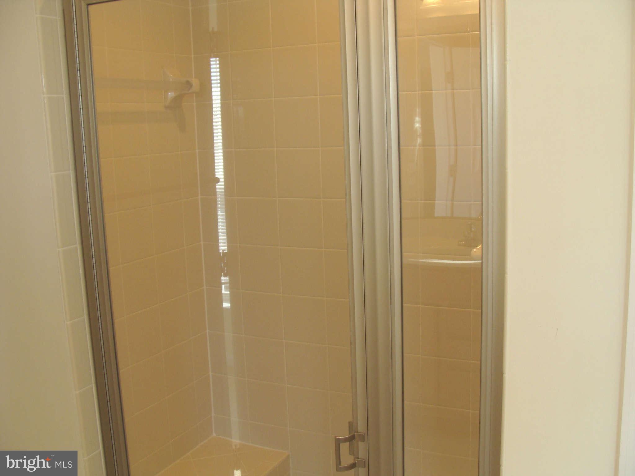 17686 Possum Point Road Dumfries, VA 22026 - Photo 14 of 23 a bathroom with a glass shower door
