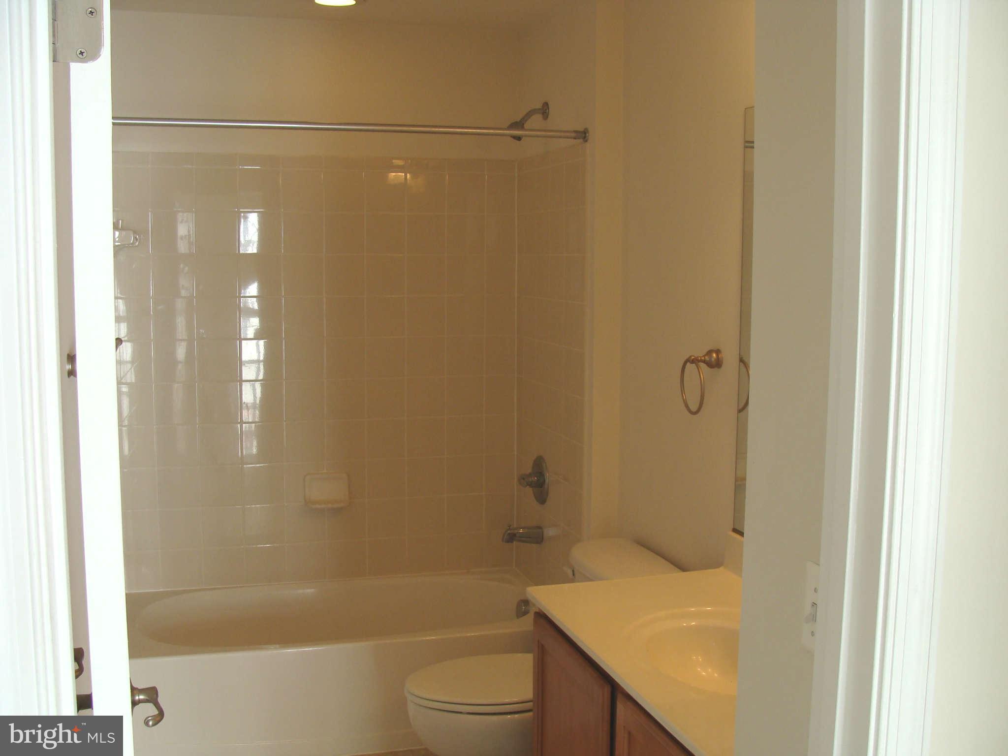 17686 Possum Point Road Dumfries, VA 22026 - Photo 8 of 23 a bathroom with a granite countertop bathtub shower sink vanity and toilet