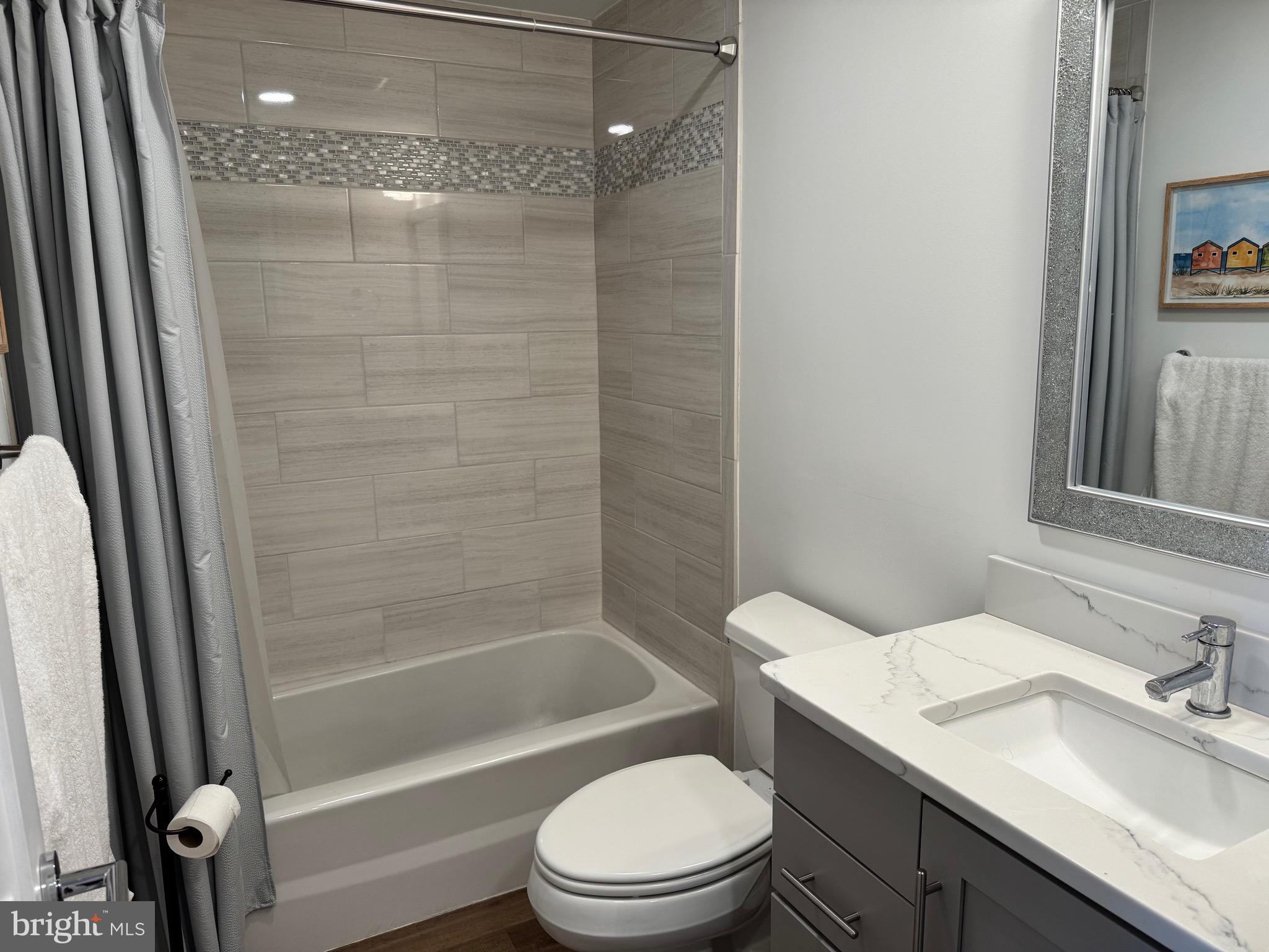 1 President Point Drive, Unit B2 Annapolis, MD 21403 - Photo 11 of 36 a bathroom with a granite countertop bathtub shower sink vanity and toilet