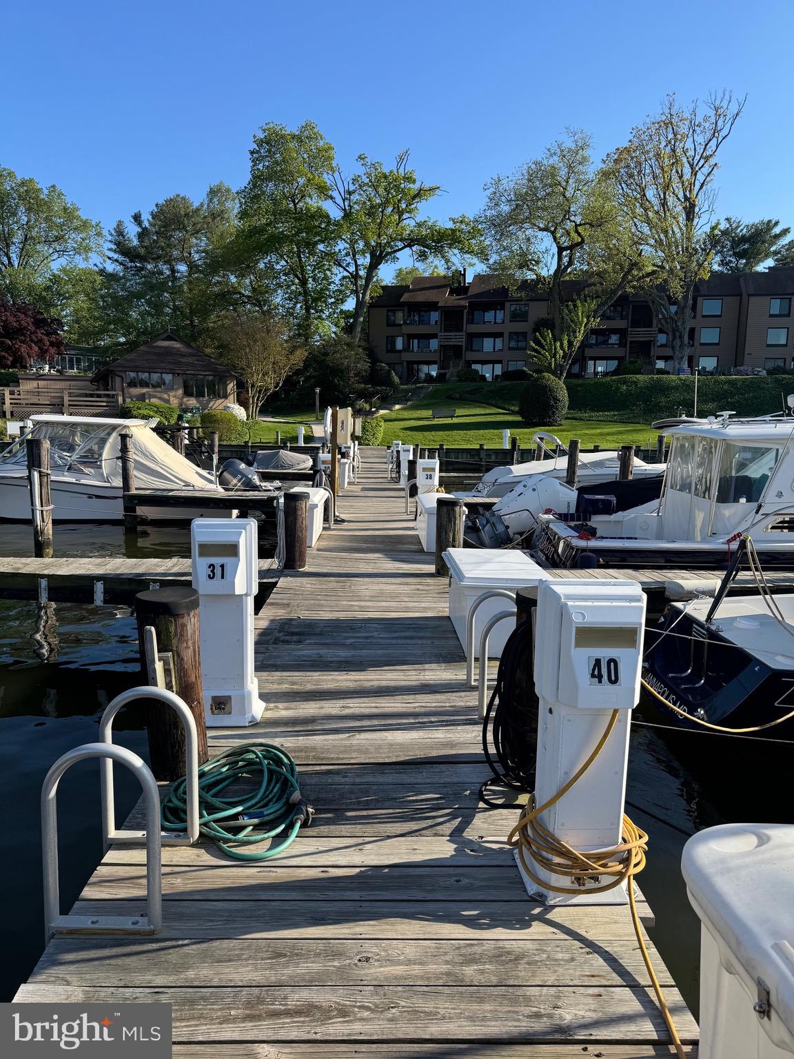 1 President Point Drive, Unit B2 Annapolis, MD 21403 - Photo 29 of 36 a view of a patio with table and chairs potted plants with palm trees