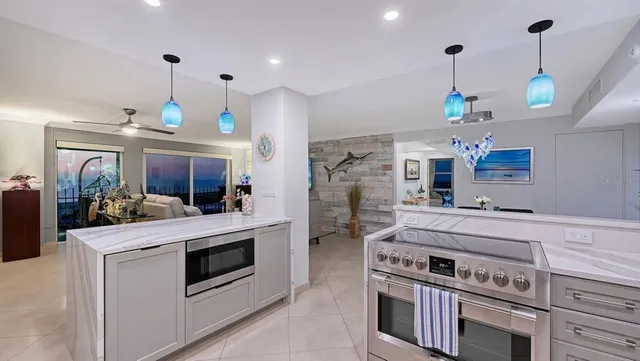 a kitchen with stainless steel appliances kitchen island a table and chairs in it
