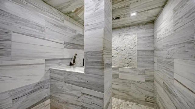 a view of a balcony with chairs and iron stairs