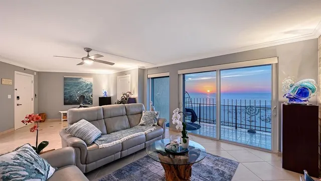 a living room with furniture and a floor to ceiling window