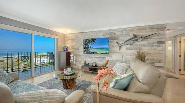 a living room with furniture and a floor to ceiling window