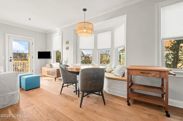 a dining room with furniture a chandelier and window