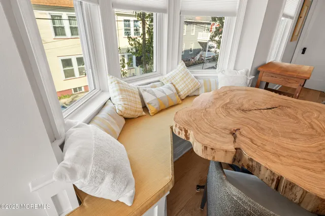 a view of a bedroom with furniture and a window