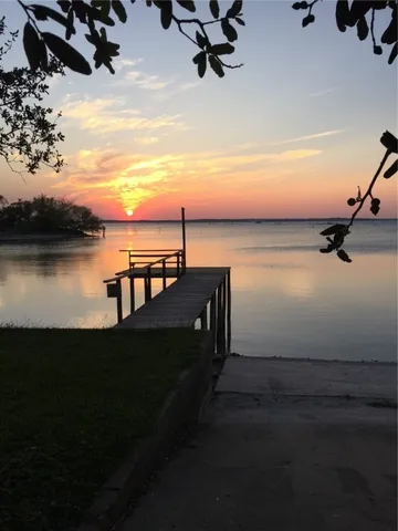 a living room with furniture a chandelier and a fireplace