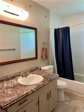 a bathroom with a glass door shower door and a sink