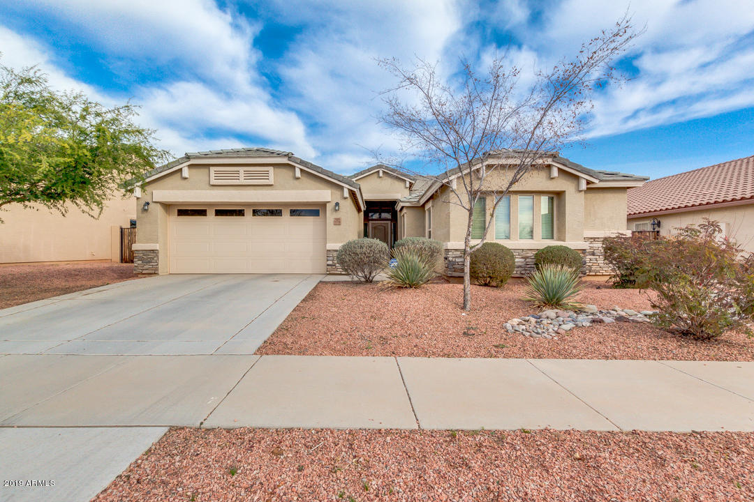 17776 West Charter Oak Road Surprise, AZ 85388 - Photo 1 of 35 a front view of a house with garden