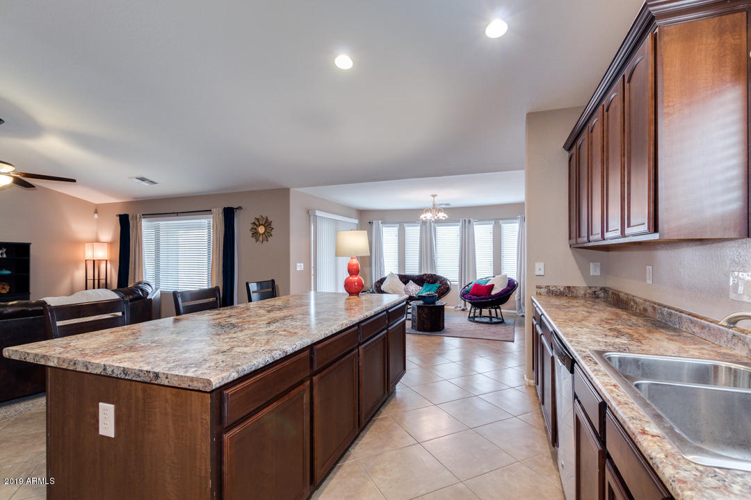 17776 West Charter Oak Road Surprise, AZ 85388 - Photo 15 of 35 a kitchen with a stove sink and cabinets