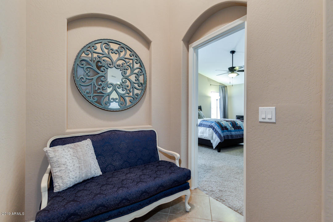 17776 West Charter Oak Road Surprise, AZ 85388 - Photo 16 of 35 a living room with furniture and a lamp