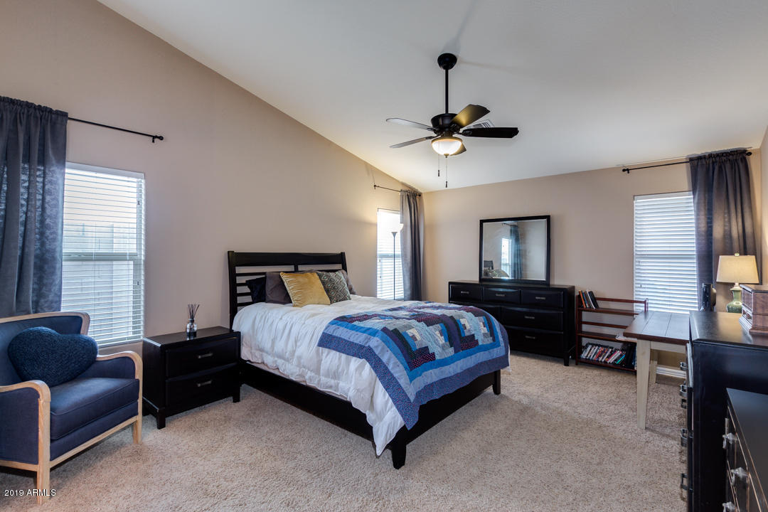 17776 West Charter Oak Road Surprise, AZ 85388 - Photo 17 of 35 a bedroom with a bed couch dresser and a window
