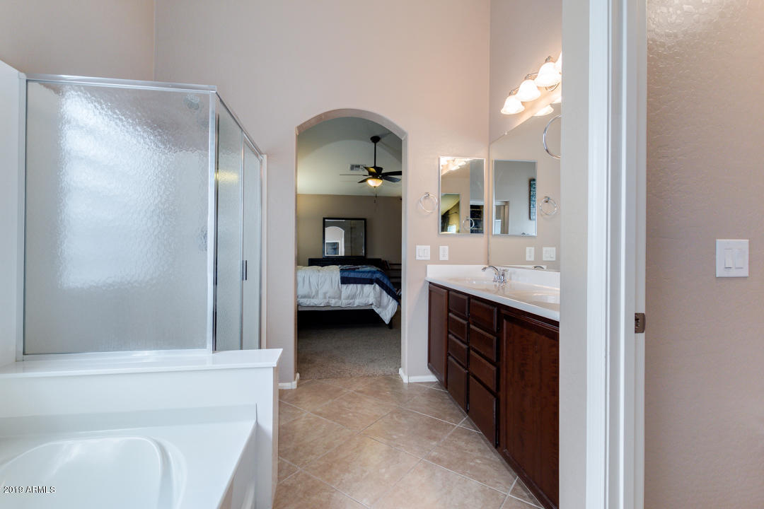 17776 West Charter Oak Road Surprise, AZ 85388 - Photo 20 of 35 a en suite spacious bathroom with a double vanity sink and a mirror