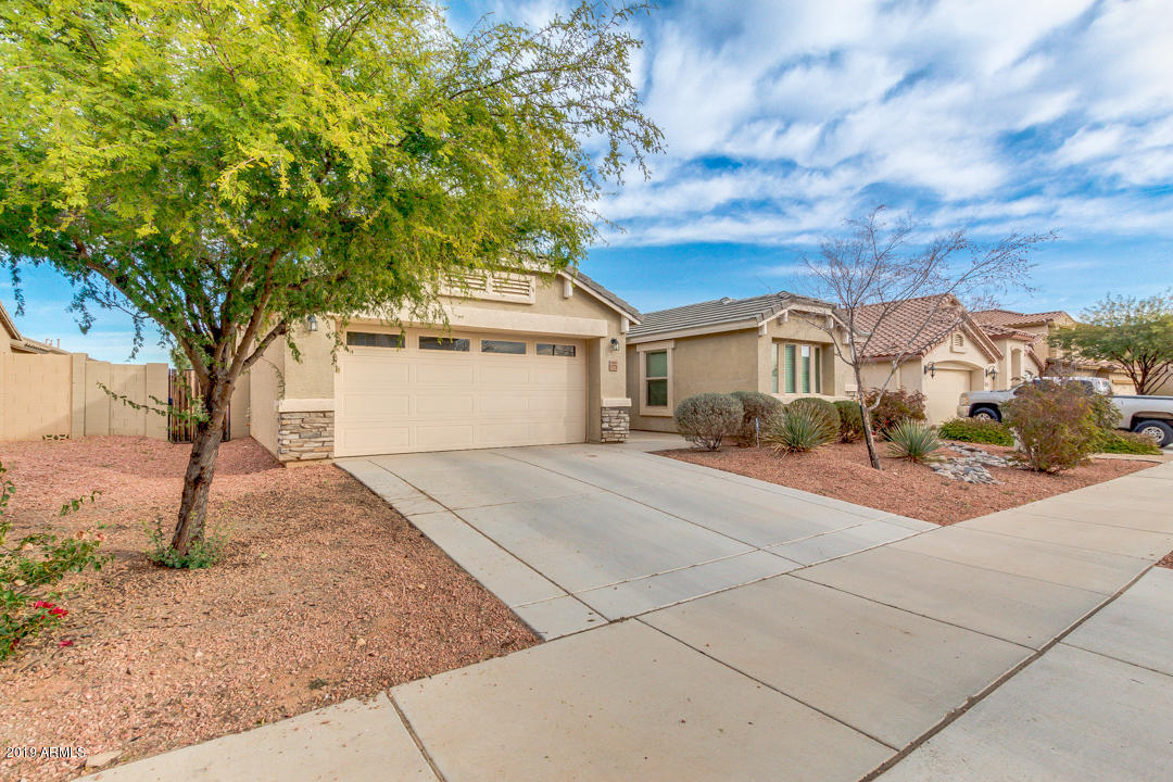 17776 West Charter Oak Road Surprise, AZ 85388 - Photo 2 of 35 a front view of a house with a yard and garage