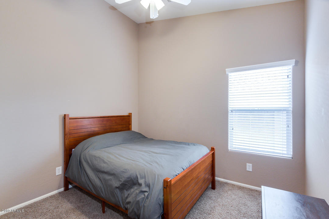 17776 West Charter Oak Road Surprise, AZ 85388 - Photo 23 of 35 a bedroom with a bed and window
