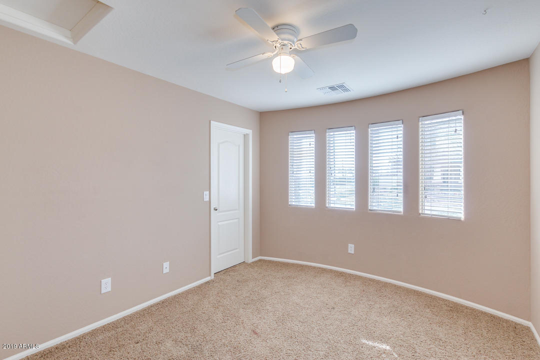 17776 West Charter Oak Road Surprise, AZ 85388 - Photo 24 of 35 an empty room with windows and ceiling fan
