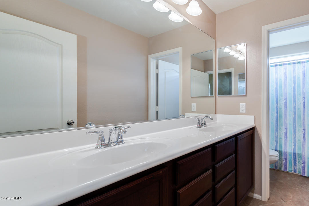 17776 West Charter Oak Road Surprise, AZ 85388 - Photo 26 of 35 a bathroom with a sink double vanity and a mirror