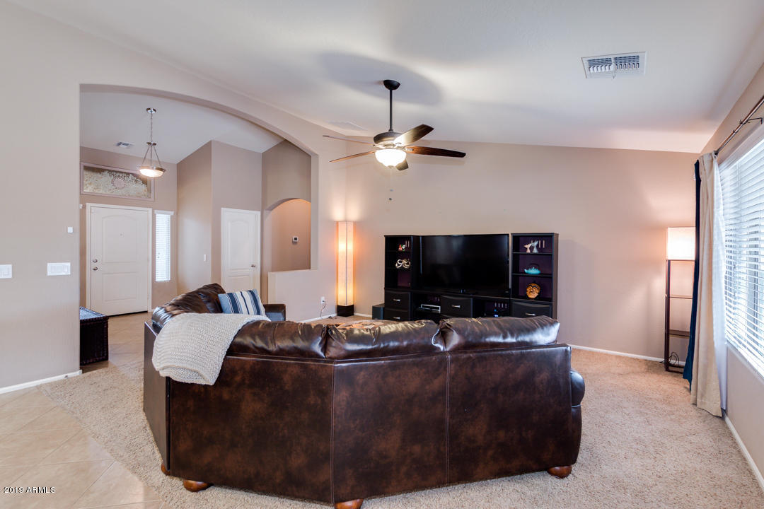 17776 West Charter Oak Road Surprise, AZ 85388 - Photo 30 of 35 a living room with furniture and a flat screen tv