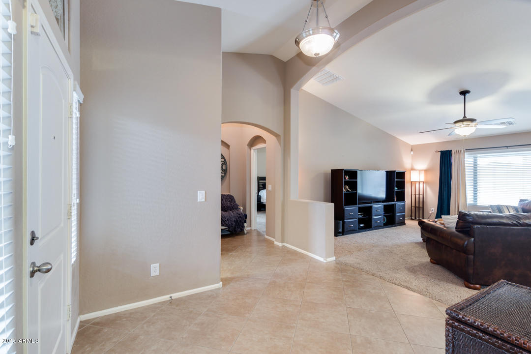 17776 West Charter Oak Road Surprise, AZ 85388 - Photo 4 of 35 a living room with furniture and a flat screen tv
