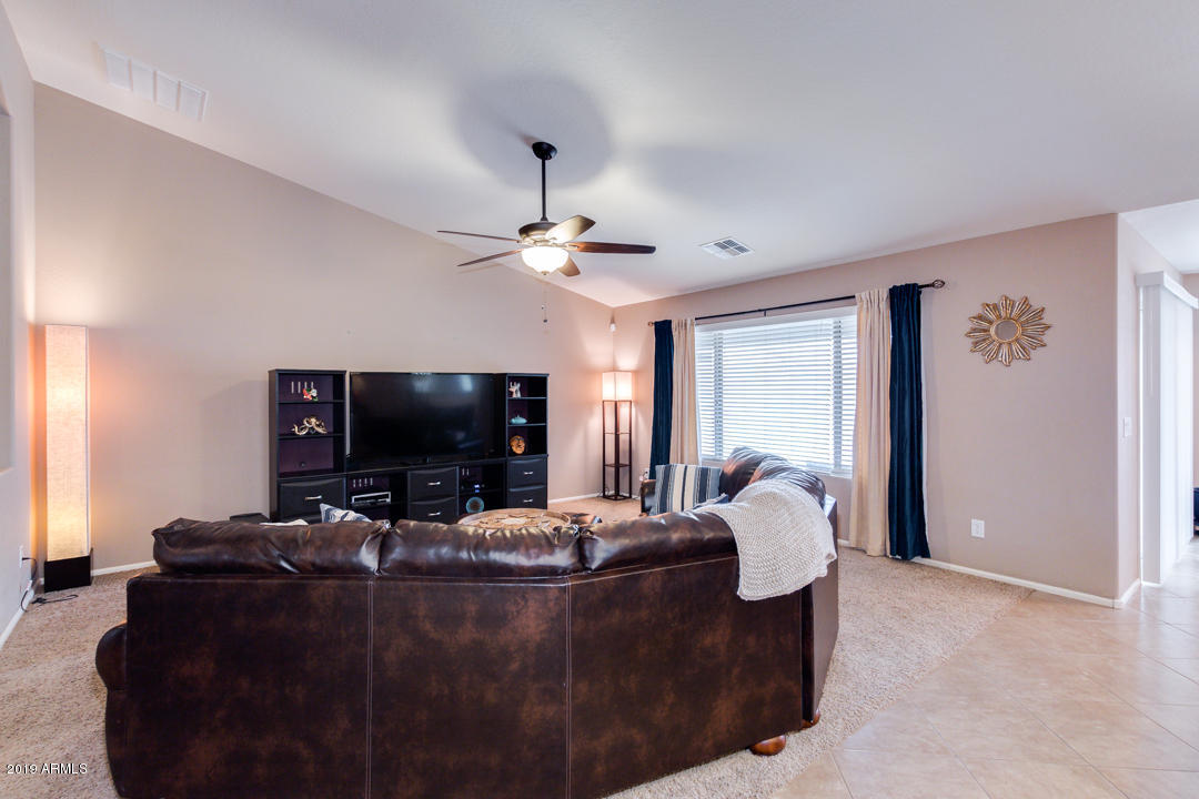 17776 West Charter Oak Road Surprise, AZ 85388 - Photo 5 of 35 a living room with furniture and a flat screen tv
