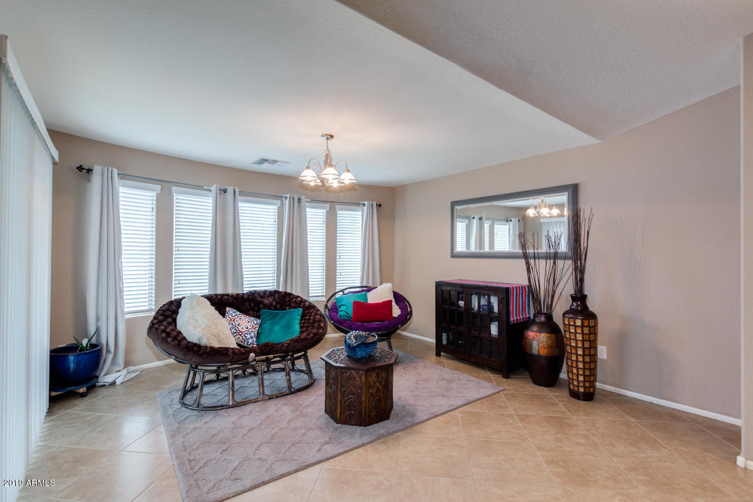 17776 West Charter Oak Road Surprise, AZ 85388 - Photo 8 of 35 a living room with furniture and chandelier