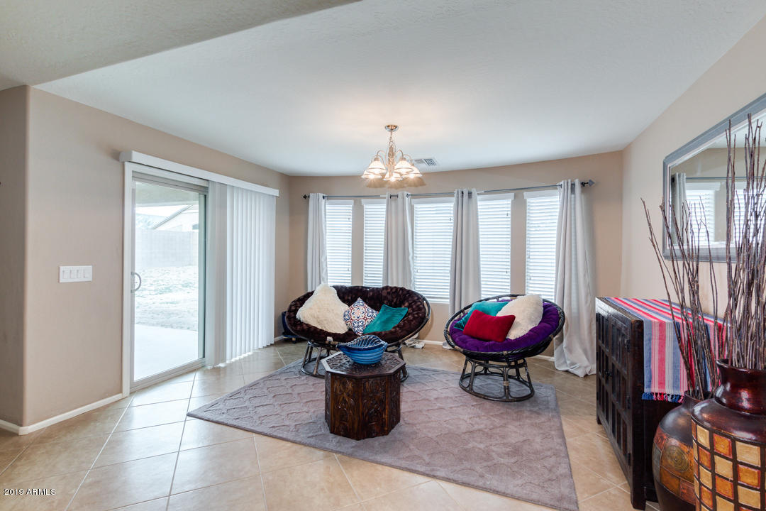 17776 West Charter Oak Road Surprise, AZ 85388 - Photo 9 of 35 a living room with furniture and a potted plant
