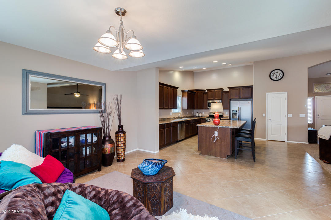 17776 West Charter Oak Road Surprise, AZ 85388 - Photo 10 of 35 a living room with furniture and a fireplace