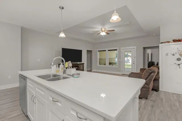 a view of kitchen with sink refrigerator dining table and chairs