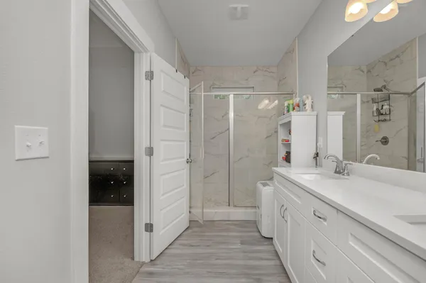 a spacious bathroom with a shower and a sink