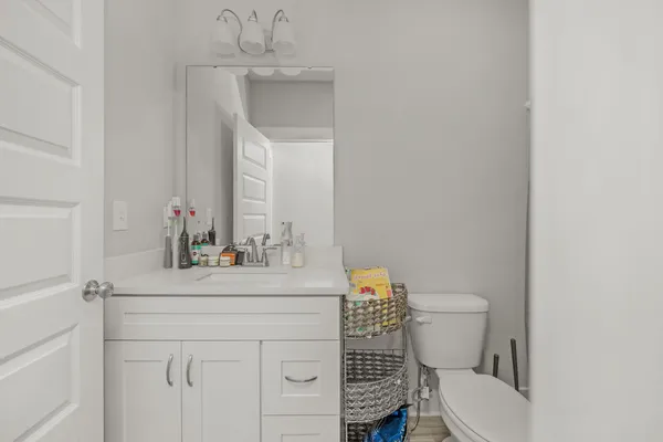 a bathroom with a sink a toilet and mirror