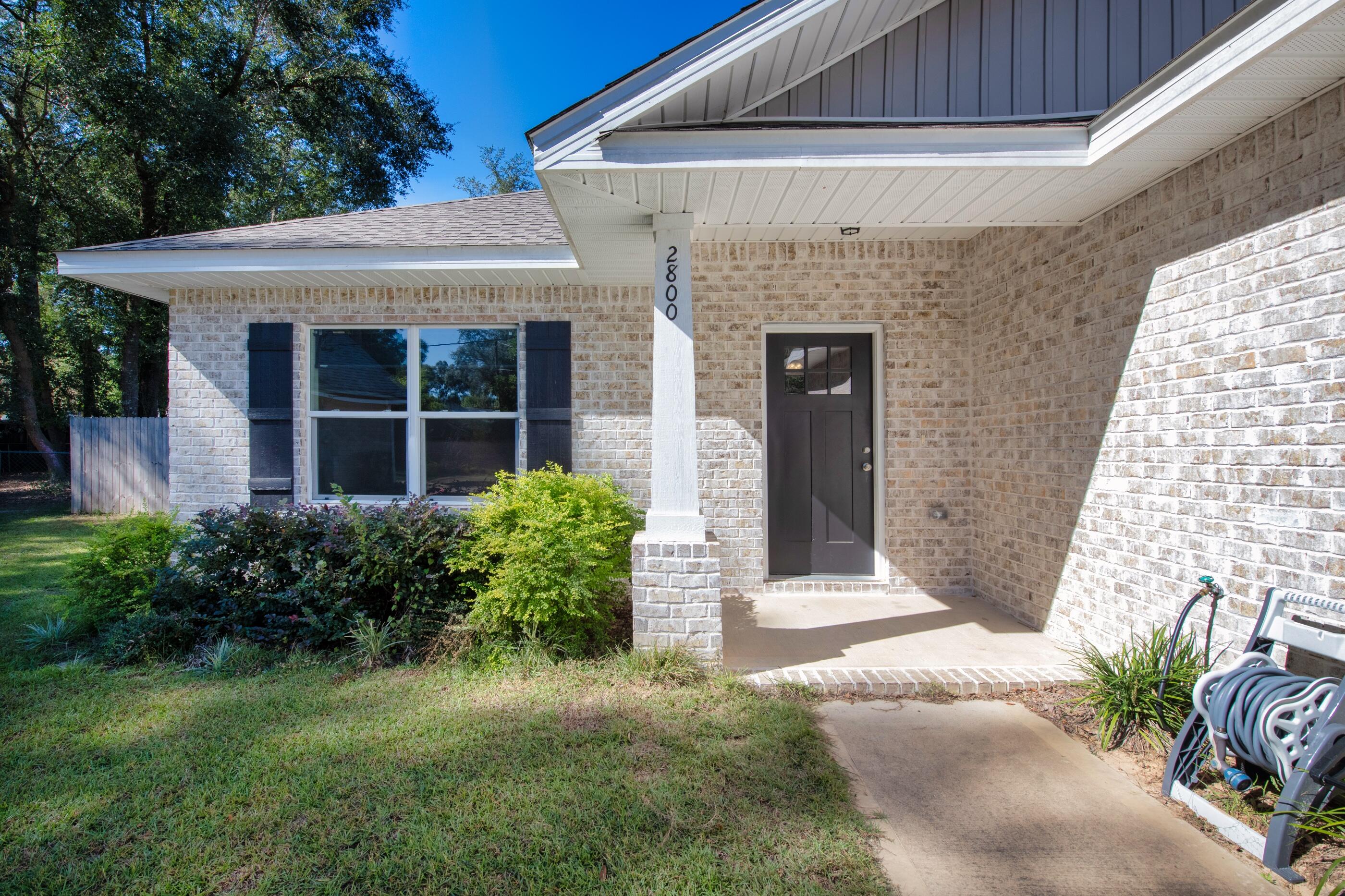 2800 Ram Lane Crestview, FL 32539 - Photo 2 of 24 a front view of a house with garden