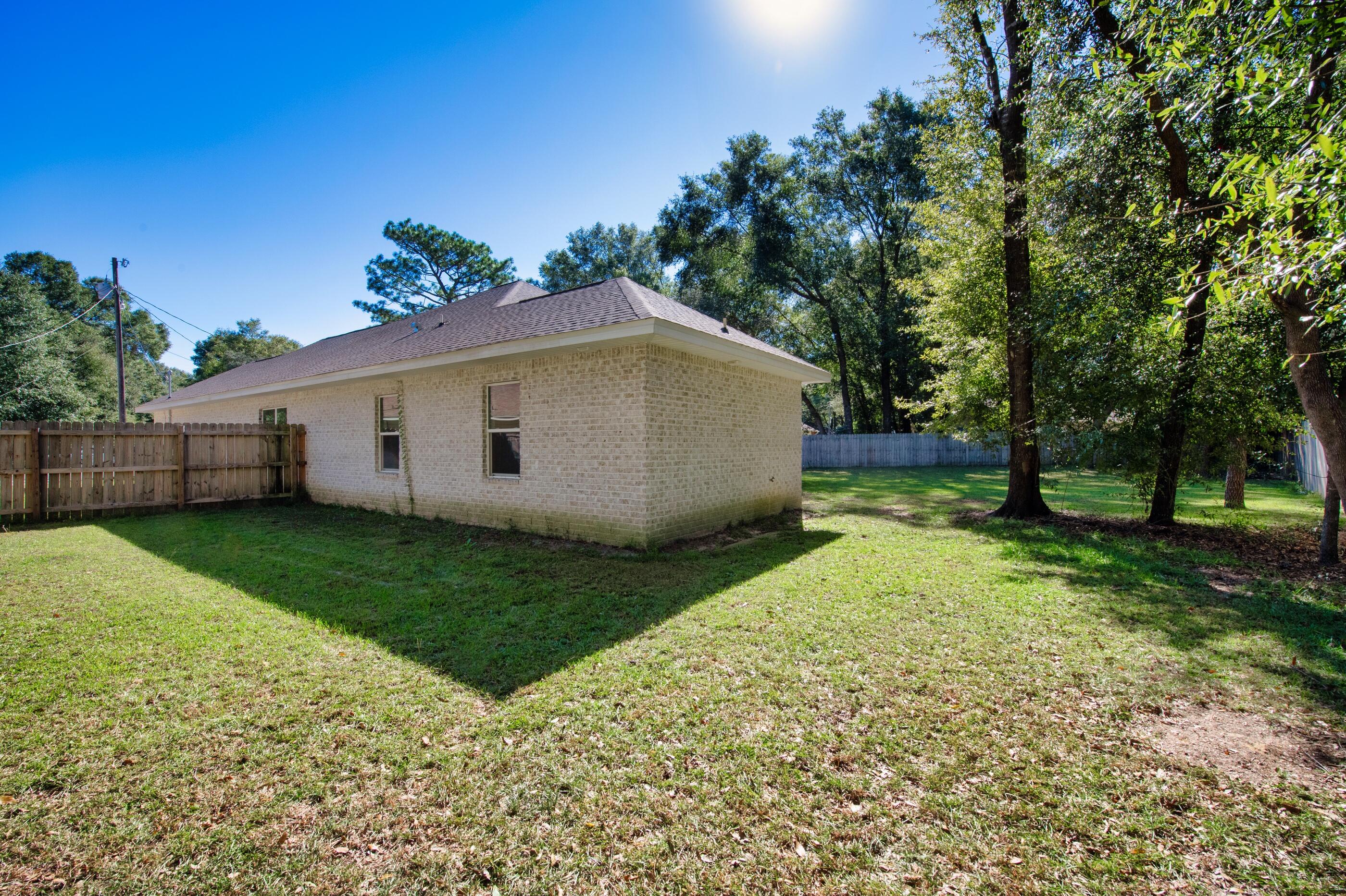 2800 Ram Lane Crestview, FL 32539 - Photo 23 of 24 a view of backyard with large trees and potted plants