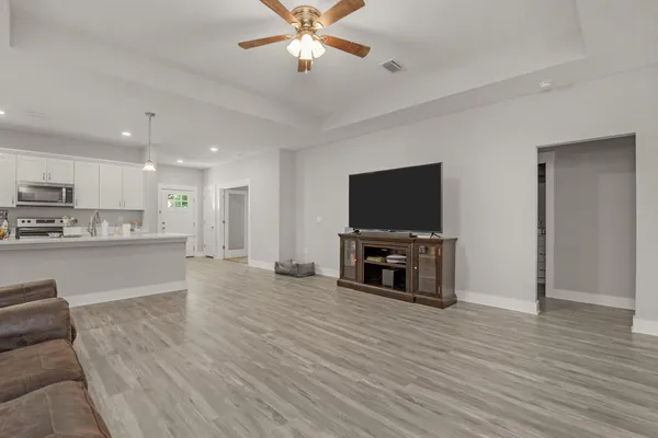 a view of kitchen with microwave and cabinets