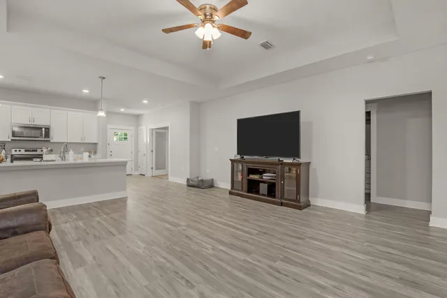 a view of kitchen with microwave and cabinets