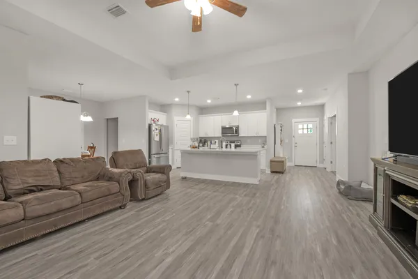a living room with furniture and a flat screen tv