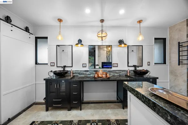 a kitchen with a sink a stove and chairs