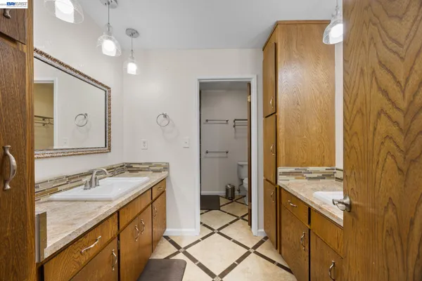 a spacious bathroom with a granite countertop sink mirror and a shower