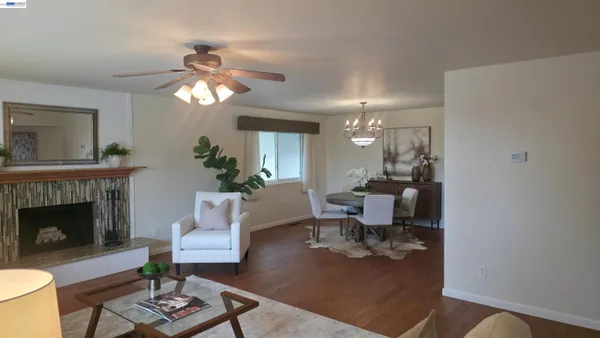 a living room with furniture a fireplace and a potted plant