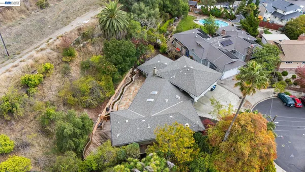 an aerial view of house with yard swimming pool and outdoor seating