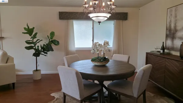 a view of a dining room with furniture wooden floor and chandelier