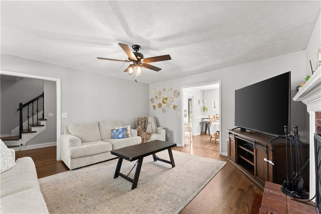 709 Muirfield Drive Winder, GA 30680 - Photo 16 of 65 a living room with furniture and a flat screen tv