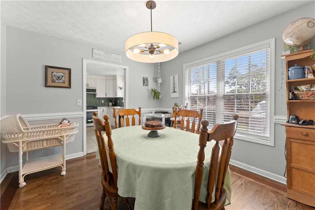 709 Muirfield Drive Winder, GA 30680 - Photo 17 of 65 a view of a dining room with furniture window and wooden floor
