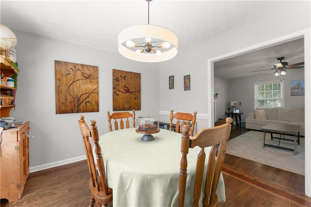 709 Muirfield Drive Winder, GA 30680 - Photo 18 of 65 a view of a dining room with furniture and wooden floor