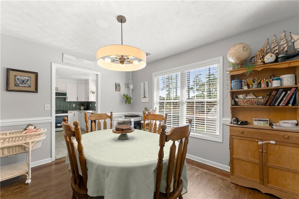 709 Muirfield Drive Winder, GA 30680 - Photo 19 of 65 a view of a dining room with furniture window and wooden floor