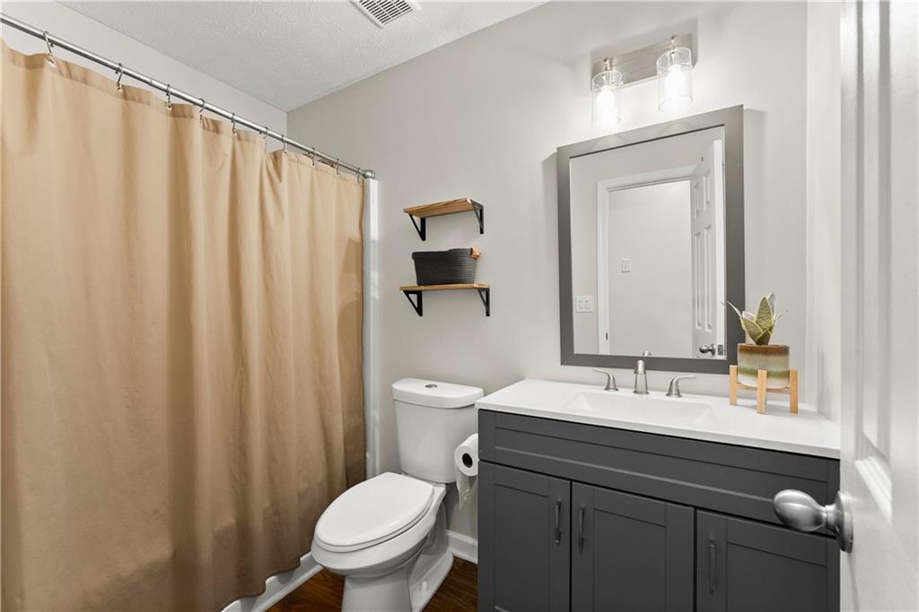 709 Muirfield Drive Winder, GA 30680 - Photo 22 of 65 a bathroom with a toilet a sink and a mirror