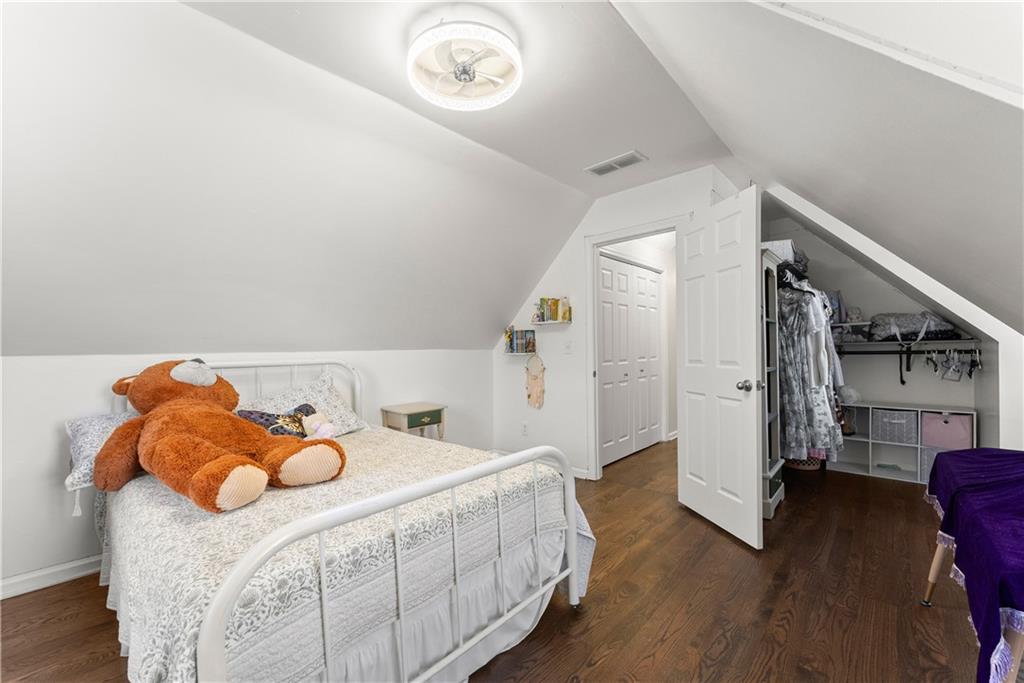 709 Muirfield Drive Winder, GA 30680 - Photo 24 of 65 a bedroom with a bed and wooden floor