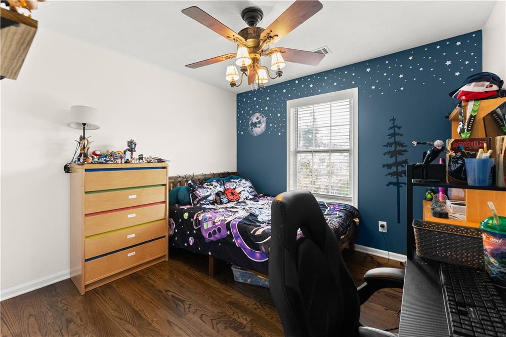 709 Muirfield Drive Winder, GA 30680 - Photo 25 of 65 a bedroom with a bed and wooden floor