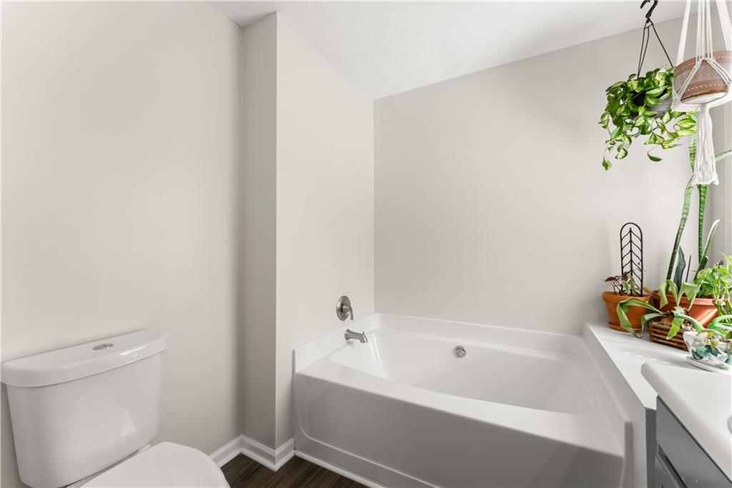 709 Muirfield Drive Winder, GA 30680 - Photo 30 of 65 a white bath tub sitting next to a white toilet