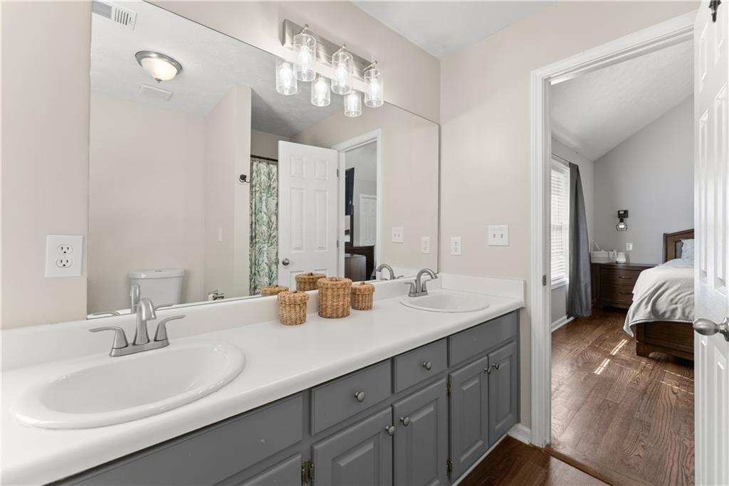 709 Muirfield Drive Winder, GA 30680 - Photo 32 of 65 a en suite bathroom with double sink and a mirror